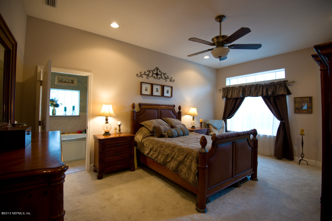 3385 Kings Road South St. Augustine, FL 32086 - Photo 16 of 36 a bed room with a bed window and a ceiling fan