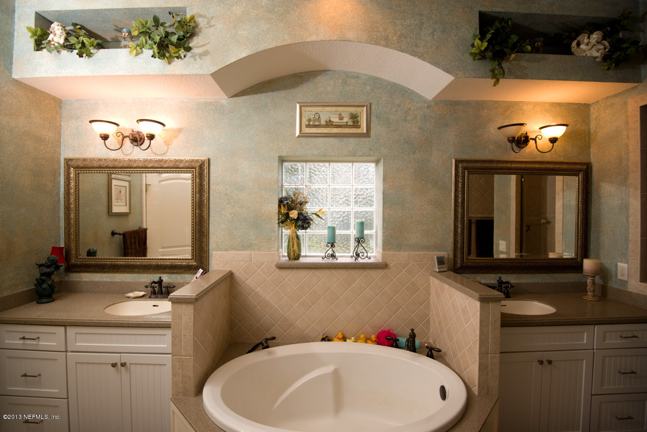 3385 Kings Road South St. Augustine, FL 32086 - Photo 17 of 36 a bathroom with a sink and a mirror