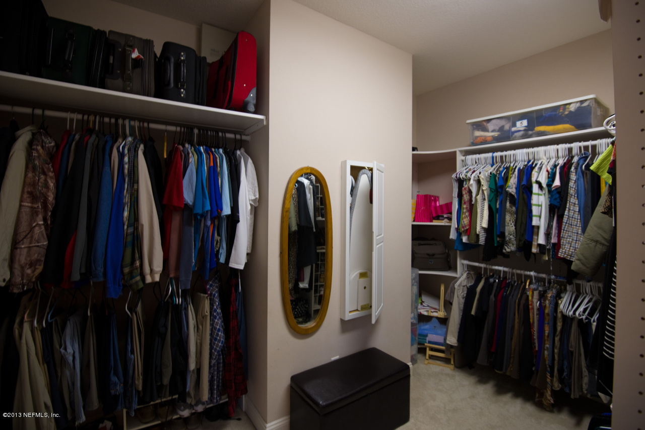 3385 Kings Road South St. Augustine, FL 32086 - Photo 19 of 36 a view of walk in closet with clothes and shoes