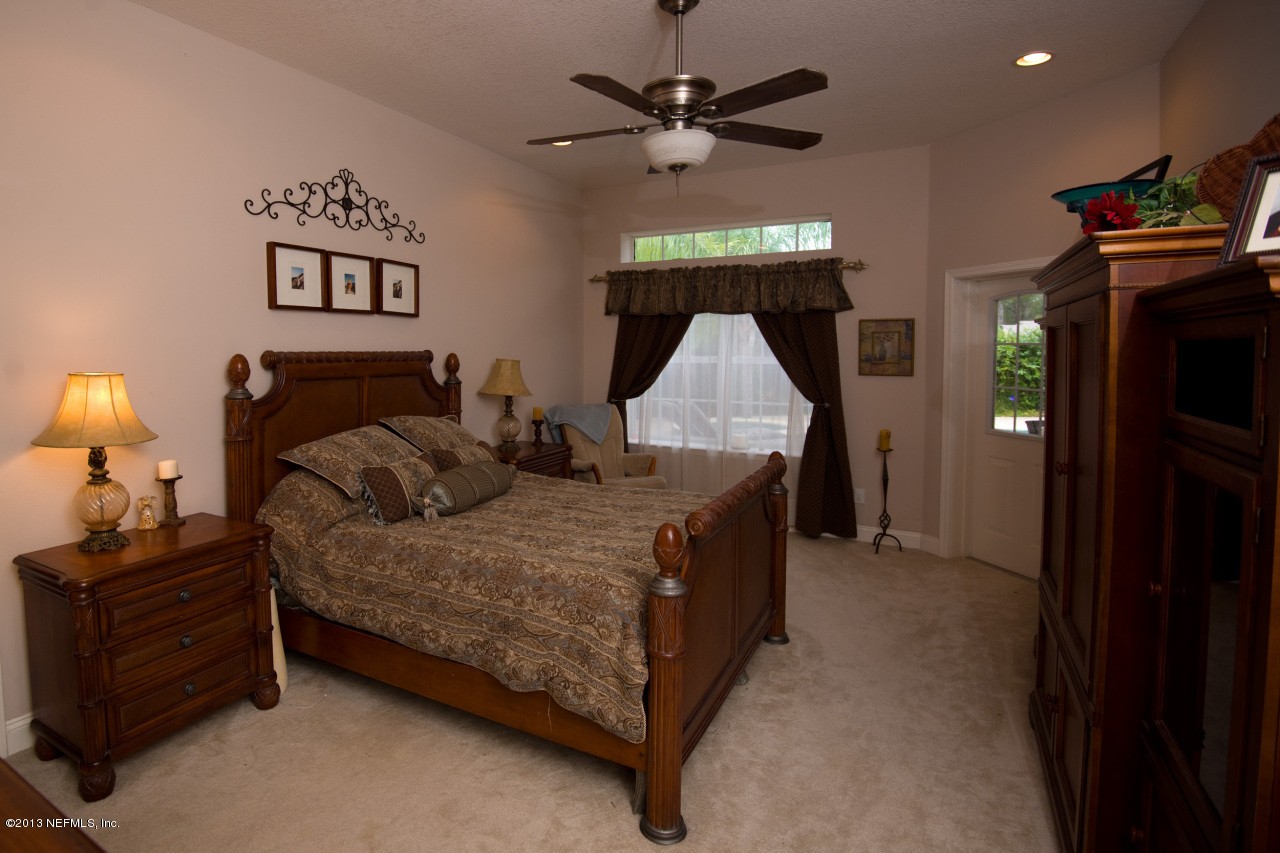 3385 Kings Road South St. Augustine, FL 32086 - Photo 20 of 36 a bed room with a bed and a ceiling fan