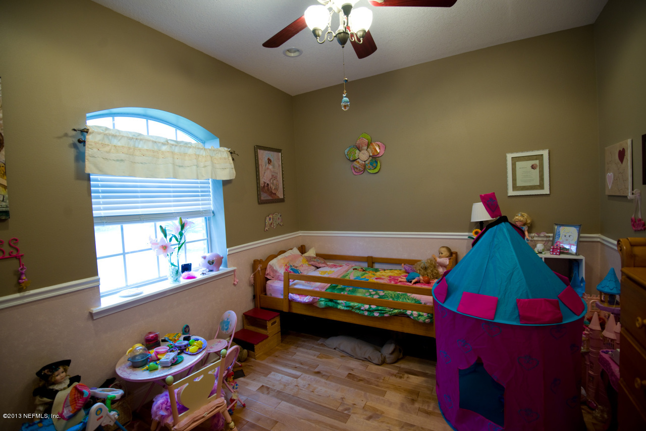 3385 Kings Road South St. Augustine, FL 32086 - Photo 22 of 36 a bedroom with toys and a window