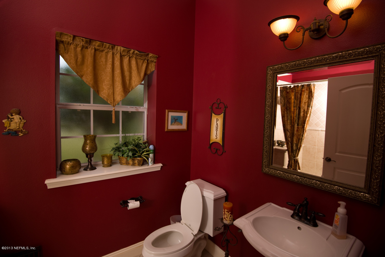 3385 Kings Road South St. Augustine, FL 32086 - Photo 23 of 36 a bathroom with a toilet sink vanity and mirror
