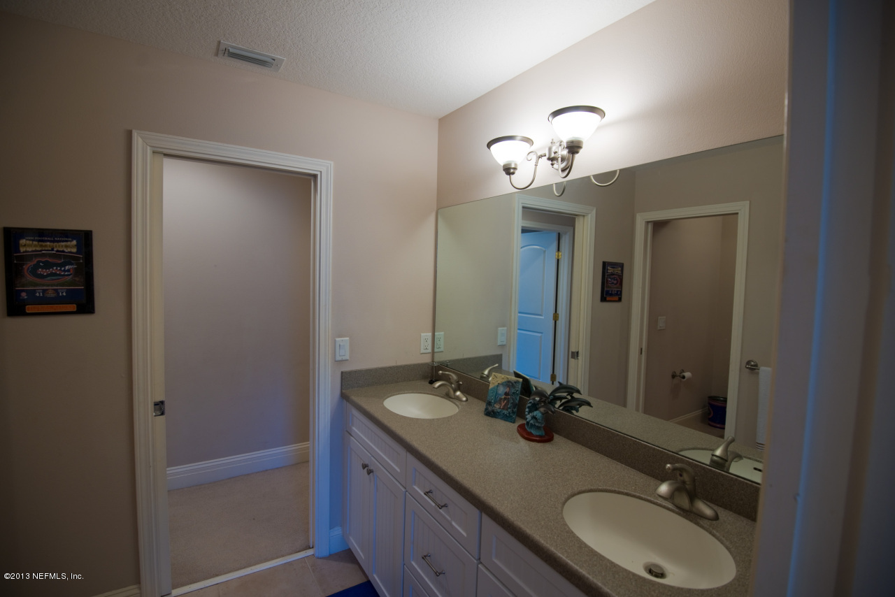 3385 Kings Road South St. Augustine, FL 32086 - Photo 25 of 36 a bathroom with a double vanity sink and a mirror