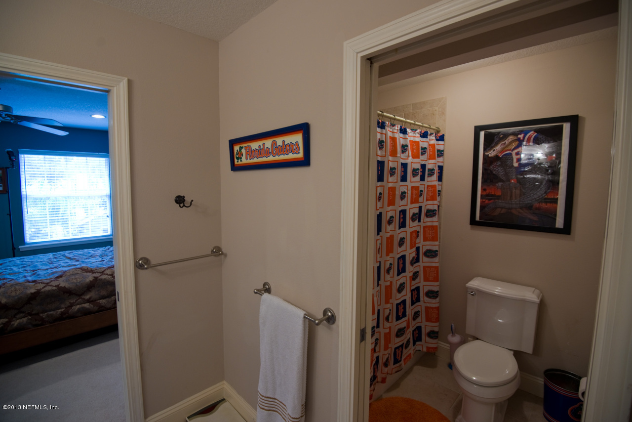 3385 Kings Road South St. Augustine, FL 32086 - Photo 26 of 36 a bathroom with a toilet and a shower curtain