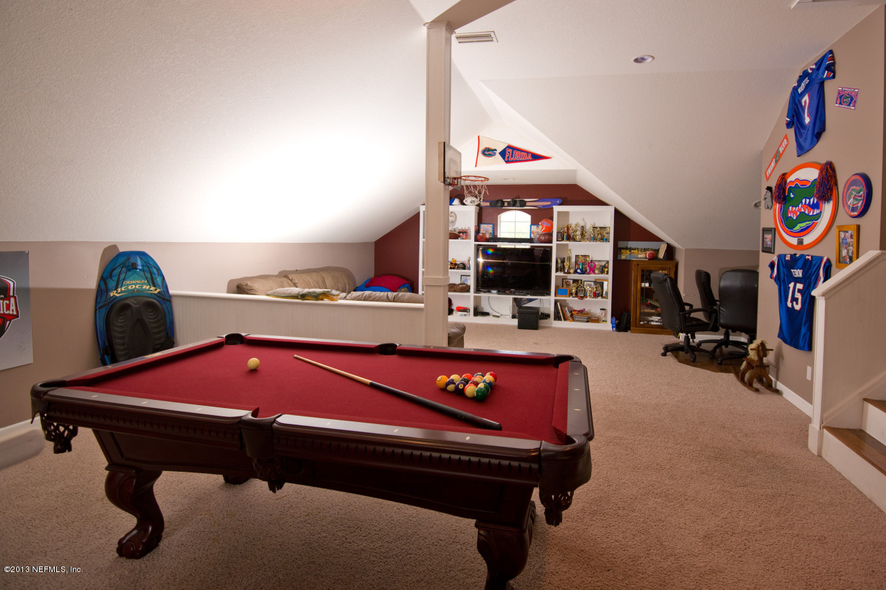 3385 Kings Road South St. Augustine, FL 32086 - Photo 28 of 36 a living room with furniture a rug and gym equipment
