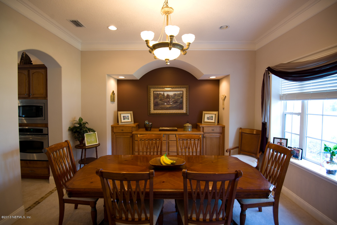 3385 Kings Road South St. Augustine, FL 32086 - Photo 9 of 36 a view of a dining room with furniture and chandelier