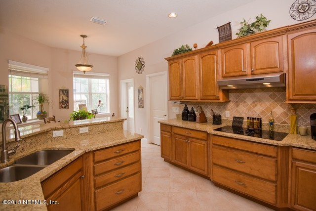 3385 Kings Road South St. Augustine, FL 32086 - Photo 10 of 36 a kitchen with stainless steel appliances granite countertop a sink a stove and cabinets