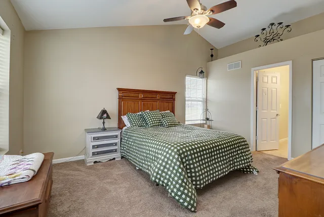 a bedroom with a bed and ceiling fan
