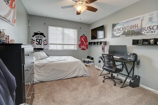 a bedroom with a bed and a chandelier