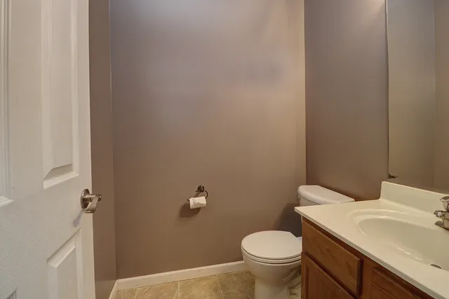 a white toilet sitting next to a bathroom sink