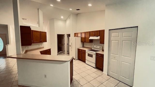 21962 Southwest Nautilus Boulevard Dunnellon, FL 34431 - Photo 11 of 12 a kitchen with stainless steel appliances granite countertop a refrigerator and a stove top oven