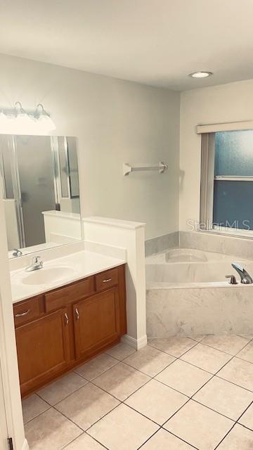 21962 Southwest Nautilus Boulevard Dunnellon, FL 34431 - Photo 7 of 12 a spacious bathroom with a tub sink and mirror