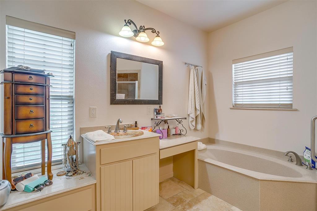383 County Road 3672 Springtown, TX 76082 - Photo 13 of 39 a bathroom with a tub sink and mirror