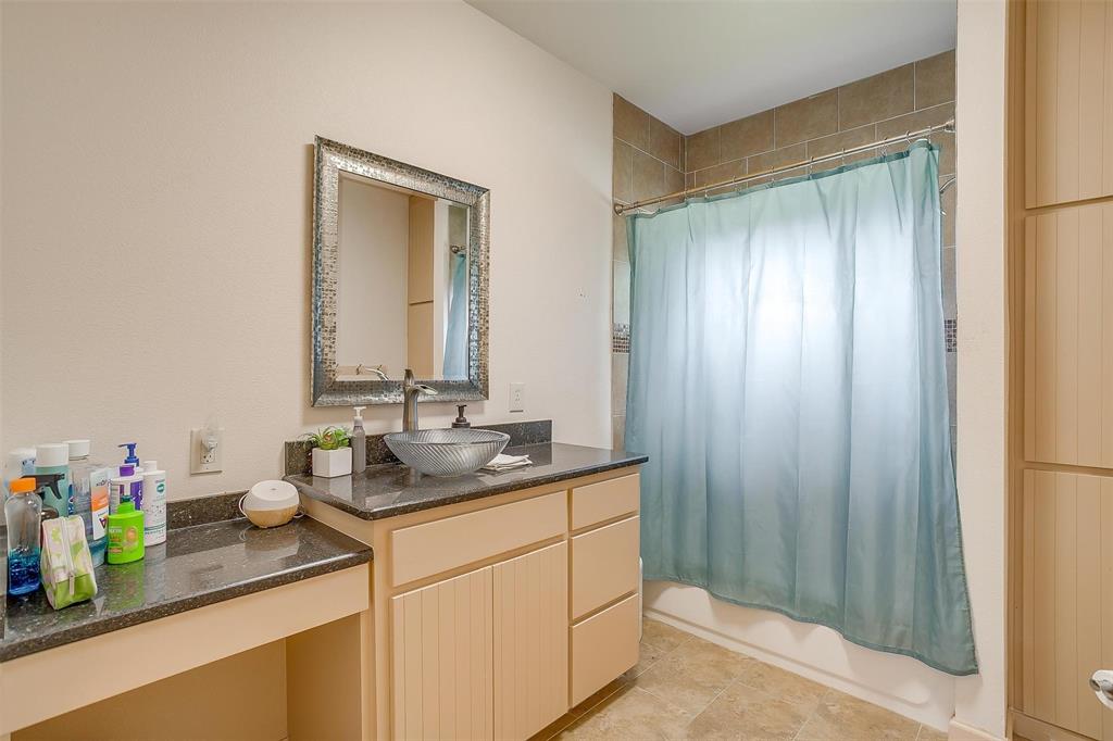 383 County Road 3672 Springtown, TX 76082 - Photo 17 of 39 a bathroom with a sink and a mirror