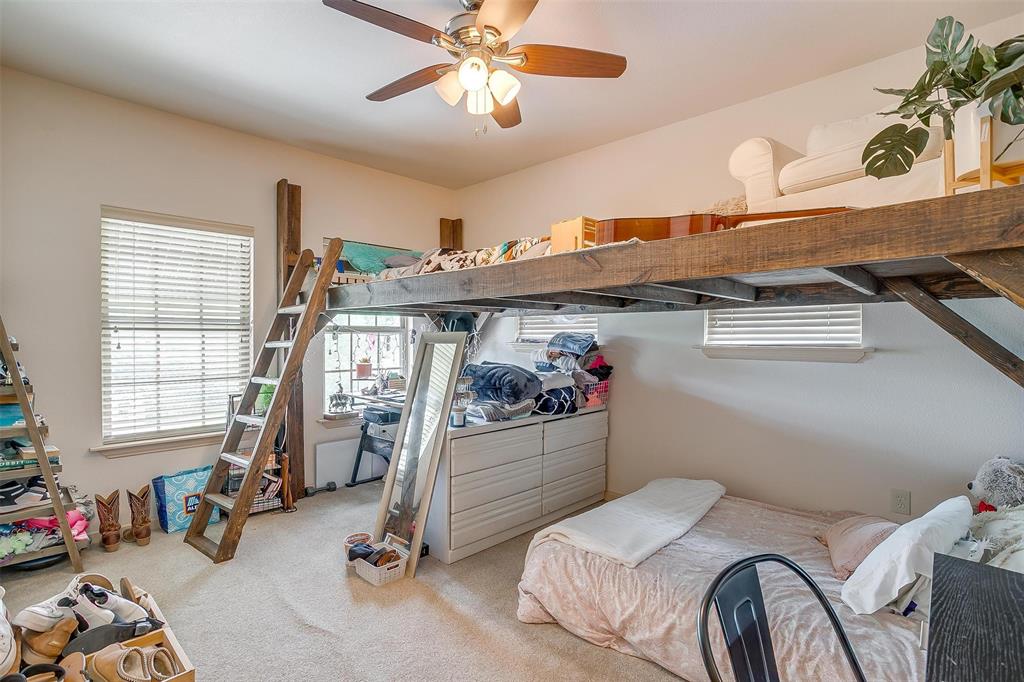 383 County Road 3672 Springtown, TX 76082 - Photo 18 of 39 a bedroom with bed and gym equipment