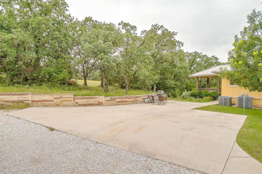 383 County Road 3672 Springtown, TX 76082 - Photo 7 of 39 a view of a house with a big yard and palm trees