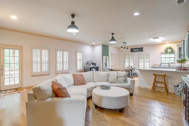 a dining room with furniture a rug and wooden floor