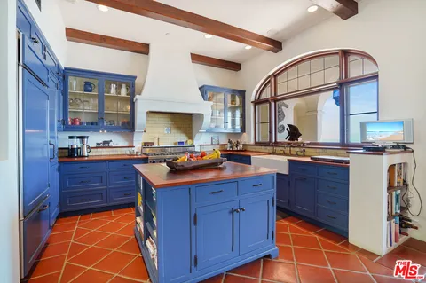 a kitchen with stainless steel appliances granite countertop a sink and cabinets