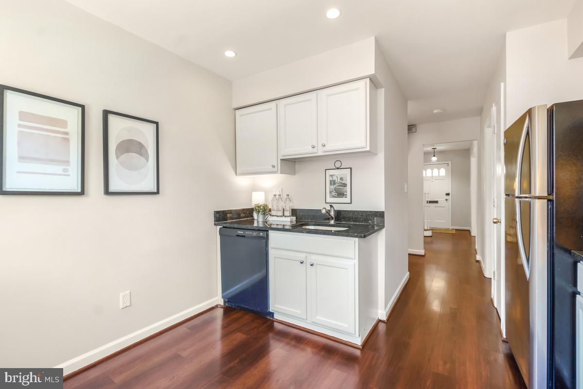 8345 Forrester Boulevard Springfield, VA 22152 - Photo 11 of 30 The kitchen has wood floors and granite counters