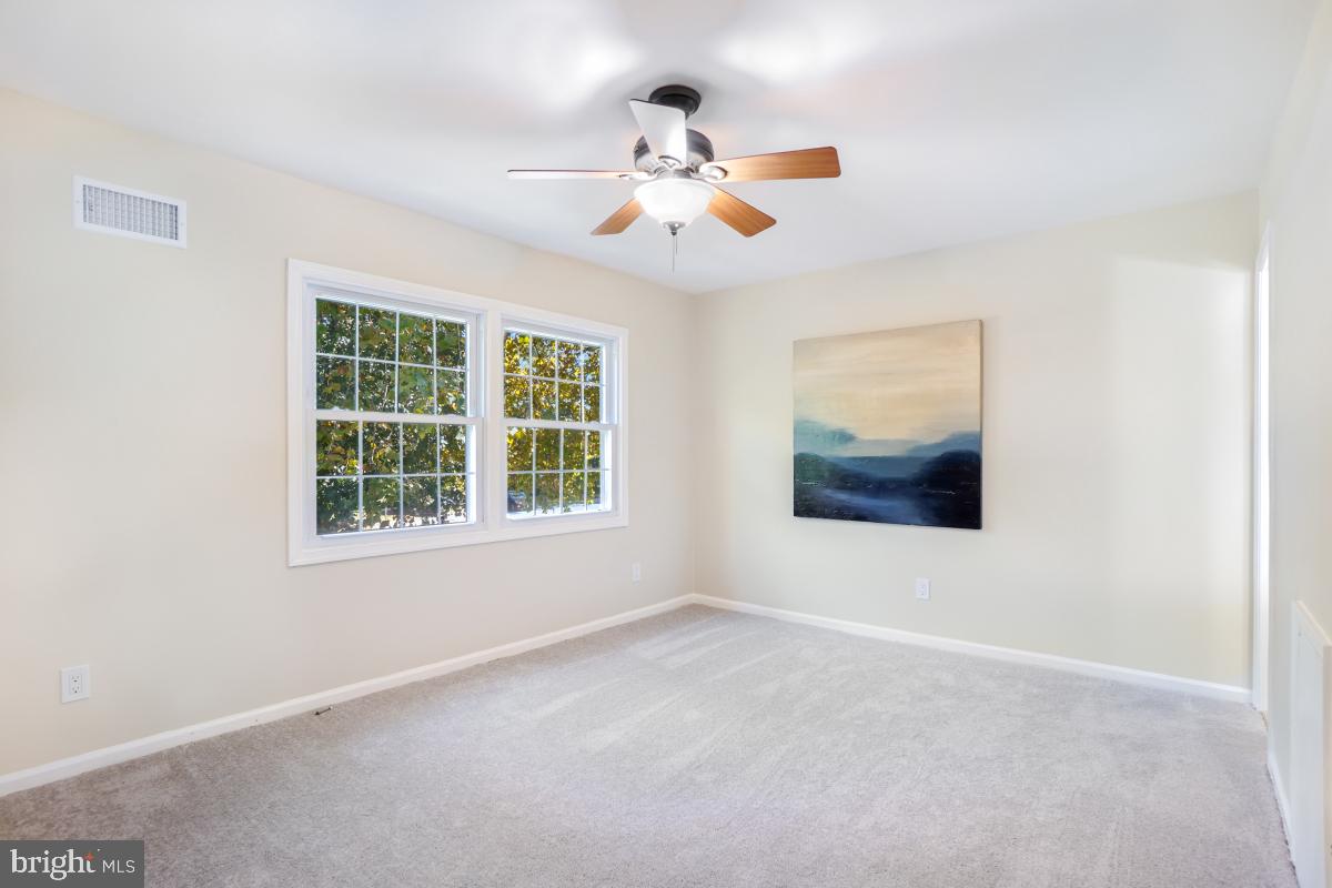 8345 Forrester Boulevard Springfield, VA 22152 - Photo 15 of 30 Spacious primary bedroom with ceiling fan .