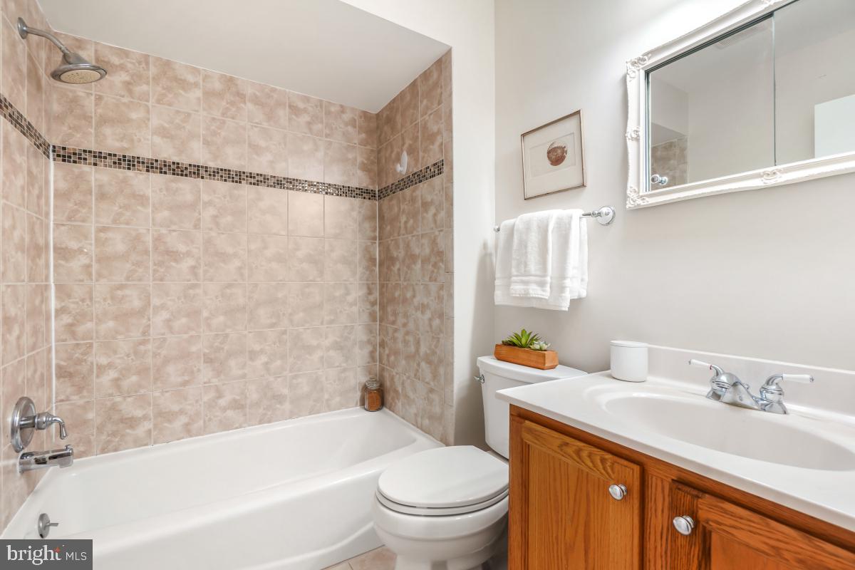 8345 Forrester Boulevard Springfield, VA 22152 - Photo 19 of 30 Full bathroom with tub and modern tile surround