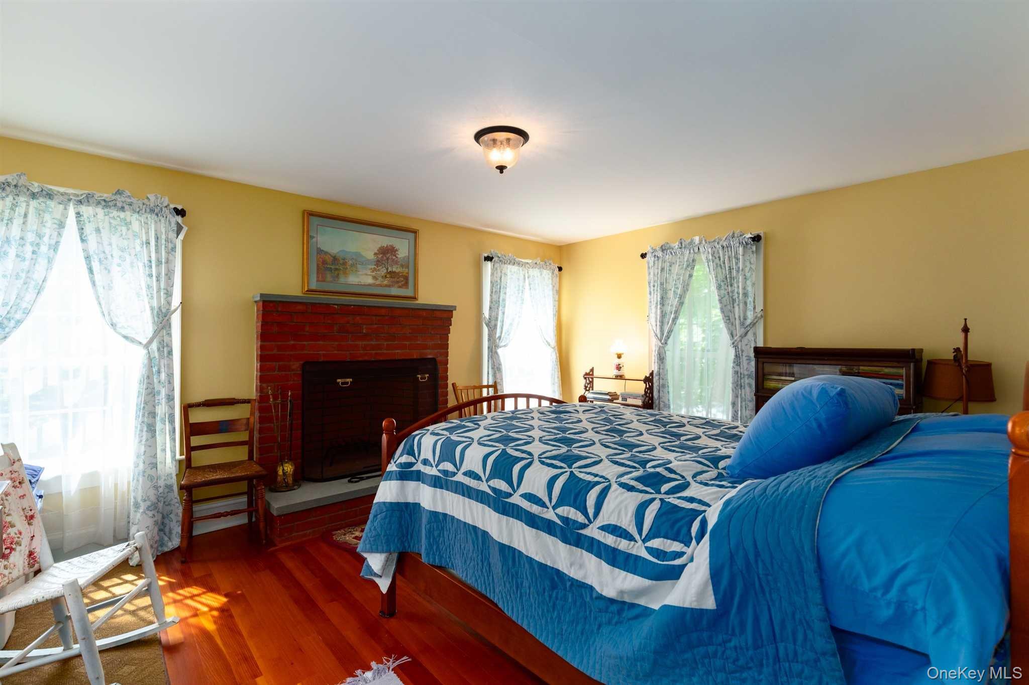 1598 Jackson Corners Road Red Hook, NY 12571 - Photo 16 of 36 a bedroom with a bed and a fireplace