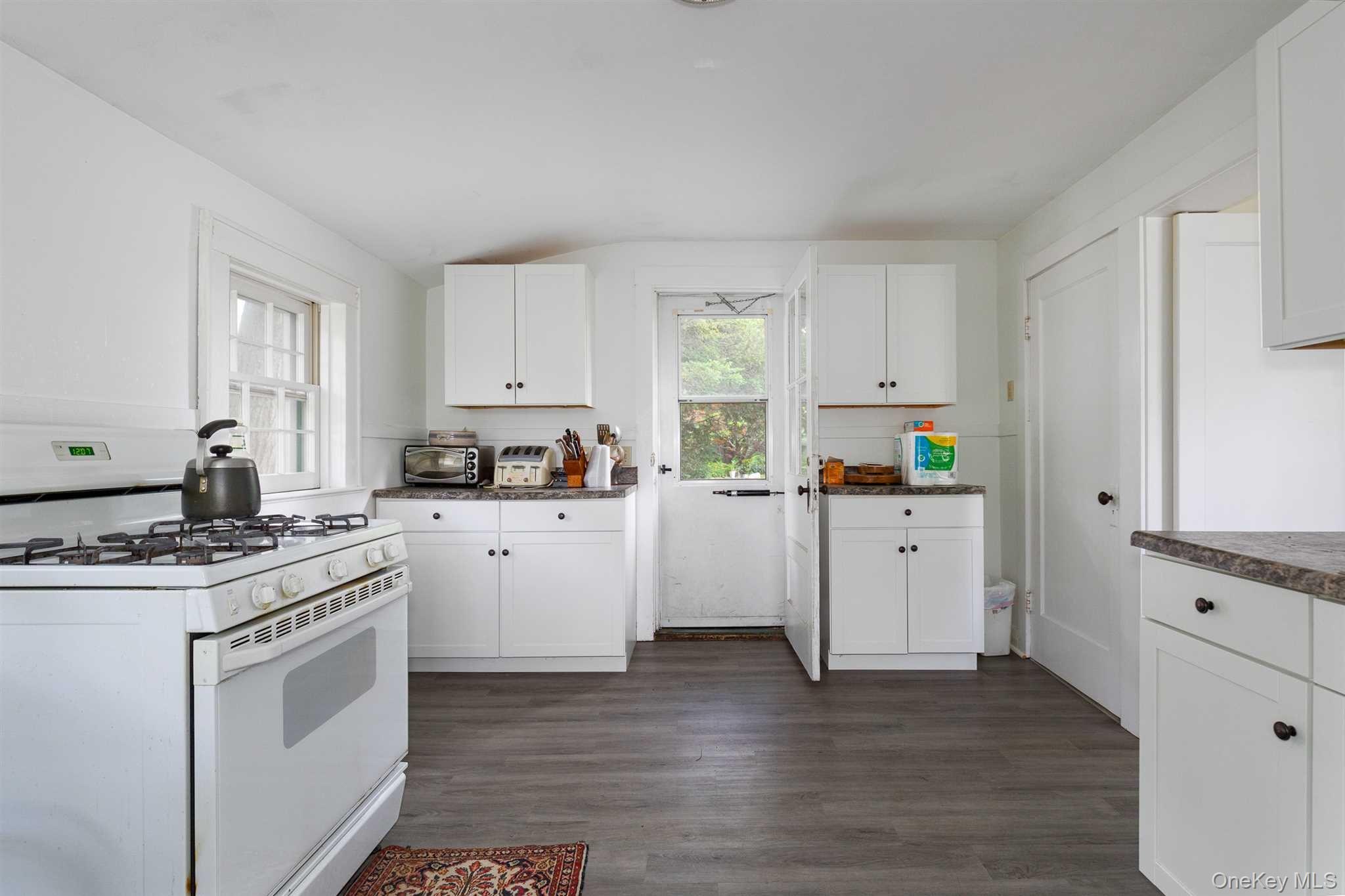 1598 Jackson Corners Road Red Hook, NY 12571 - Photo 22 of 36 a kitchen with white cabinets and white appliances