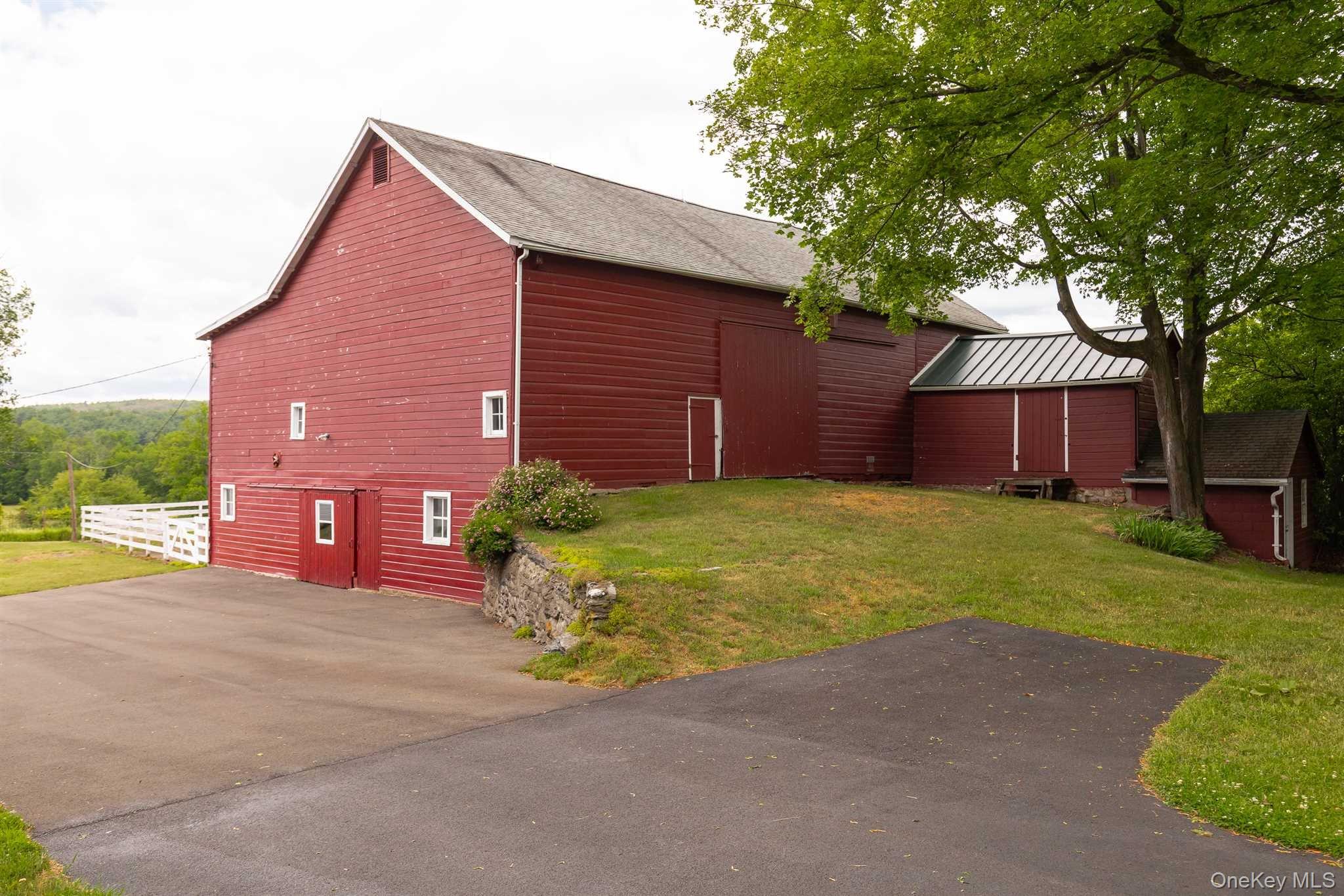 1598 Jackson Corners Road Red Hook, NY 12571 - Photo 27 of 36 a front view of a house with a yard and garage