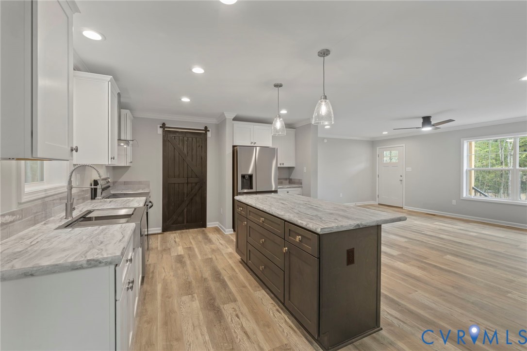 46 Union Church Road Palmyra, VA 22963 - Photo 8 of 50 Kitchen with a barn door, white cabinets, light wo