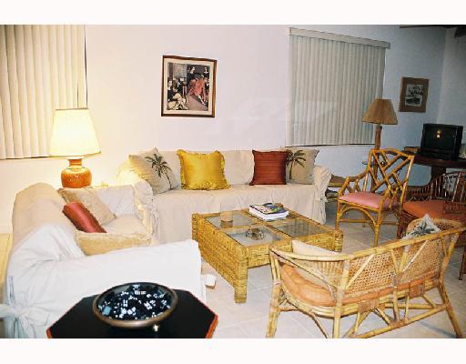 150 Southeast Four Winds Drive, Unit B410 Stuart, FL 34996 - Photo 2 of 4 a living room with furniture a couch and a table