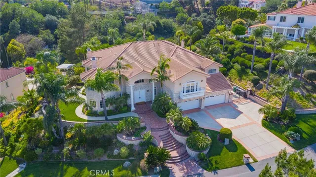 a view of a house with backyard sitting area and garden