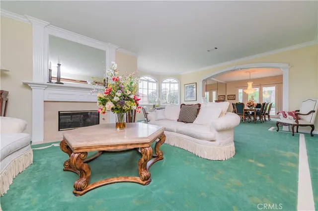 a dining room with wooden floor a chandelier a wooden table and chairs