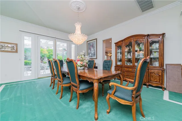 a large white kitchen with a large counter top and stainless steel appliances
