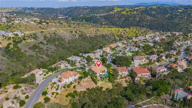 a living room with furniture a fireplace and a large window