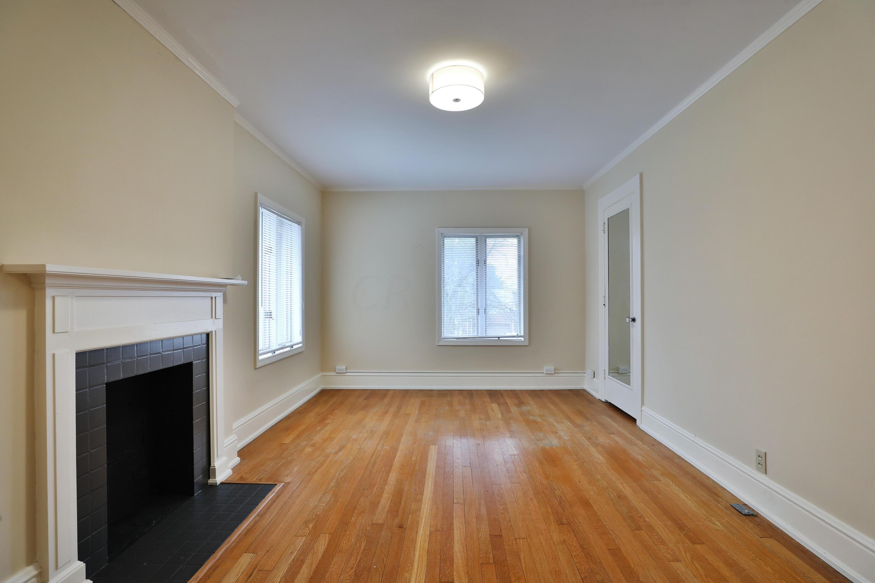 2180 Bryden Road Columbus, OH 43209 - Photo 30 of 56 Decorative fireplace, crown molding, original hardwood floor