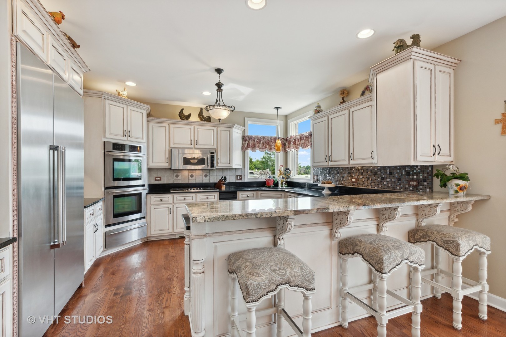 21170 Sage Brush Lane Mokena, IL 60448 - Photo 24 of 66 a kitchen with stainless steel appliances kitchen island granite countertop a refrigerator and a stove top oven