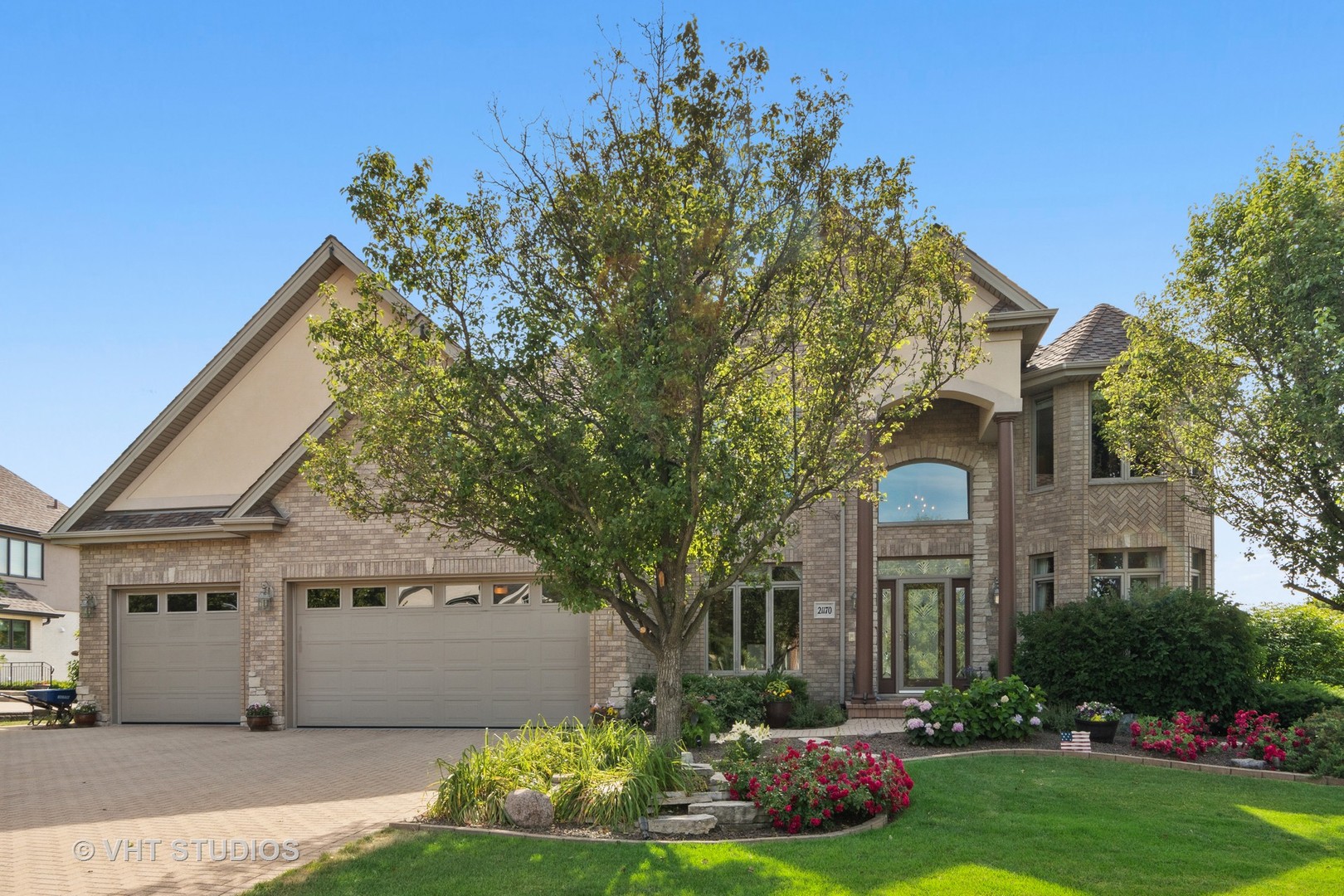21170 Sage Brush Lane Mokena, IL 60448 - Photo 56 of 66 a front view of a house with a garden and tree
