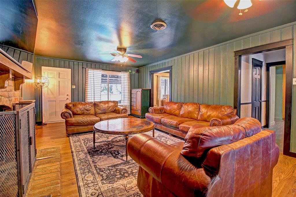 3615 Fritz Lane Corinth, TX 76208 - Photo 16 of 28 a living room with furniture a large window and a chandelier