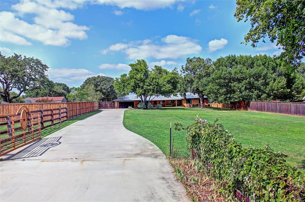 3615 Fritz Lane Corinth, TX 76208 - Photo 2 of 28 a view of a garden with a fountain