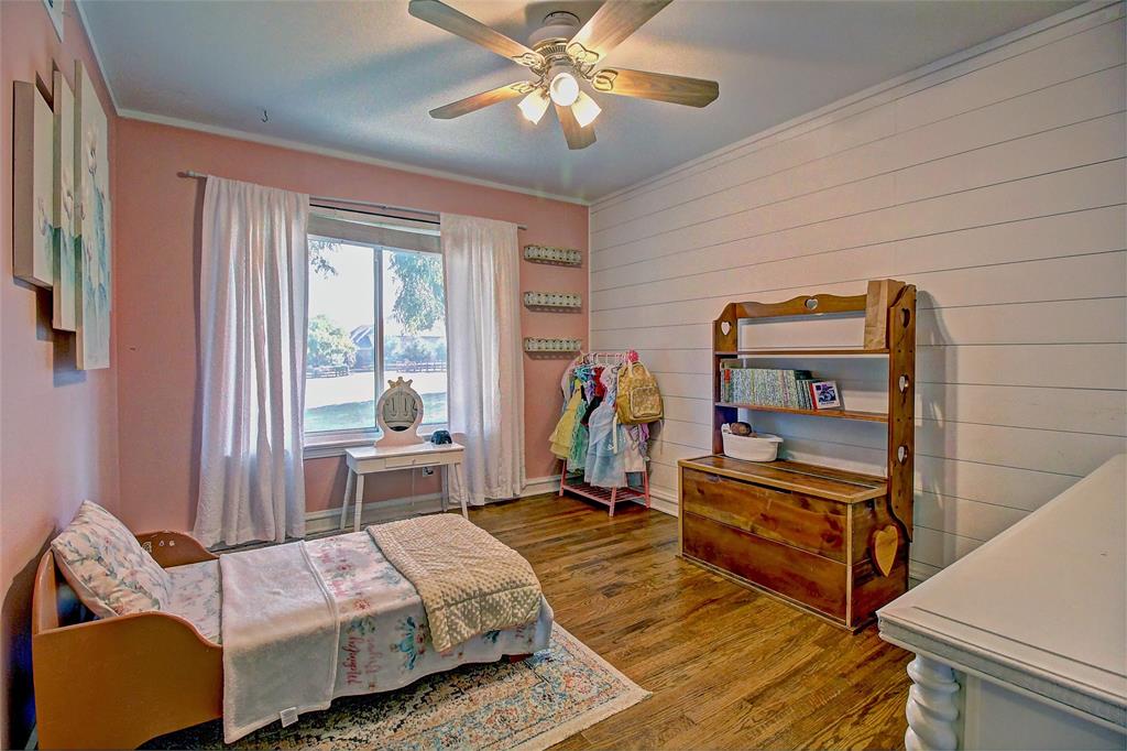 3615 Fritz Lane Corinth, TX 76208 - Photo 21 of 28 a bedroom with bed and a chandelier