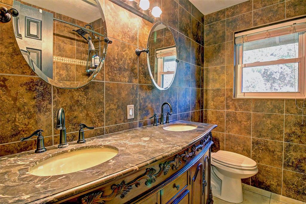 3615 Fritz Lane Corinth, TX 76208 - Photo 22 of 28 a bathroom with a sink a toilet and a mirror