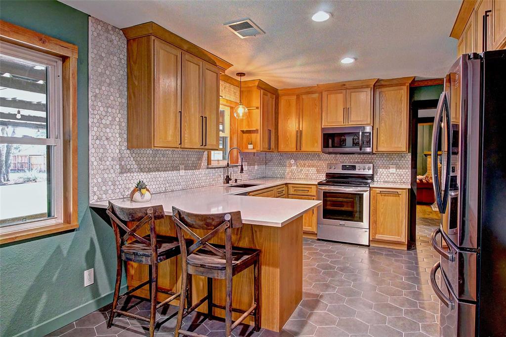 3615 Fritz Lane Corinth, TX 76208 - Photo 9 of 28 a kitchen with stainless steel appliances a stove top oven a sink dishwasher and a refrigerator