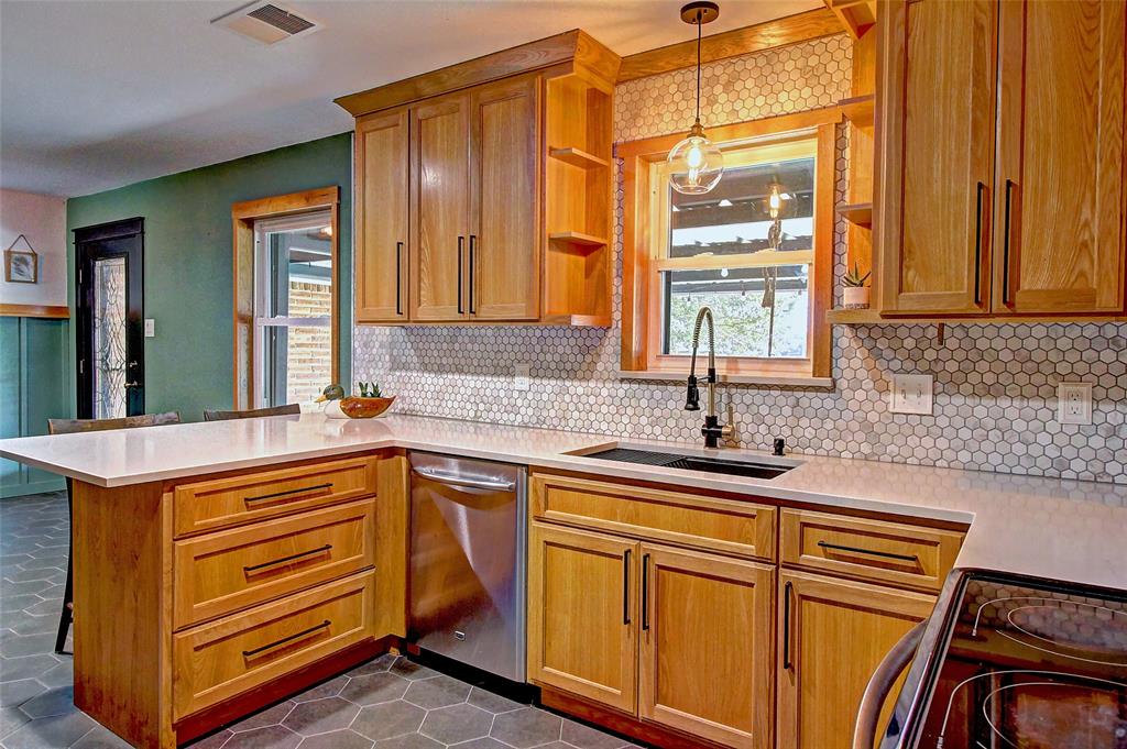 3615 Fritz Lane Corinth, TX 76208 - Photo 10 of 28 a kitchen with stainless steel appliances granite countertop a sink and cabinets