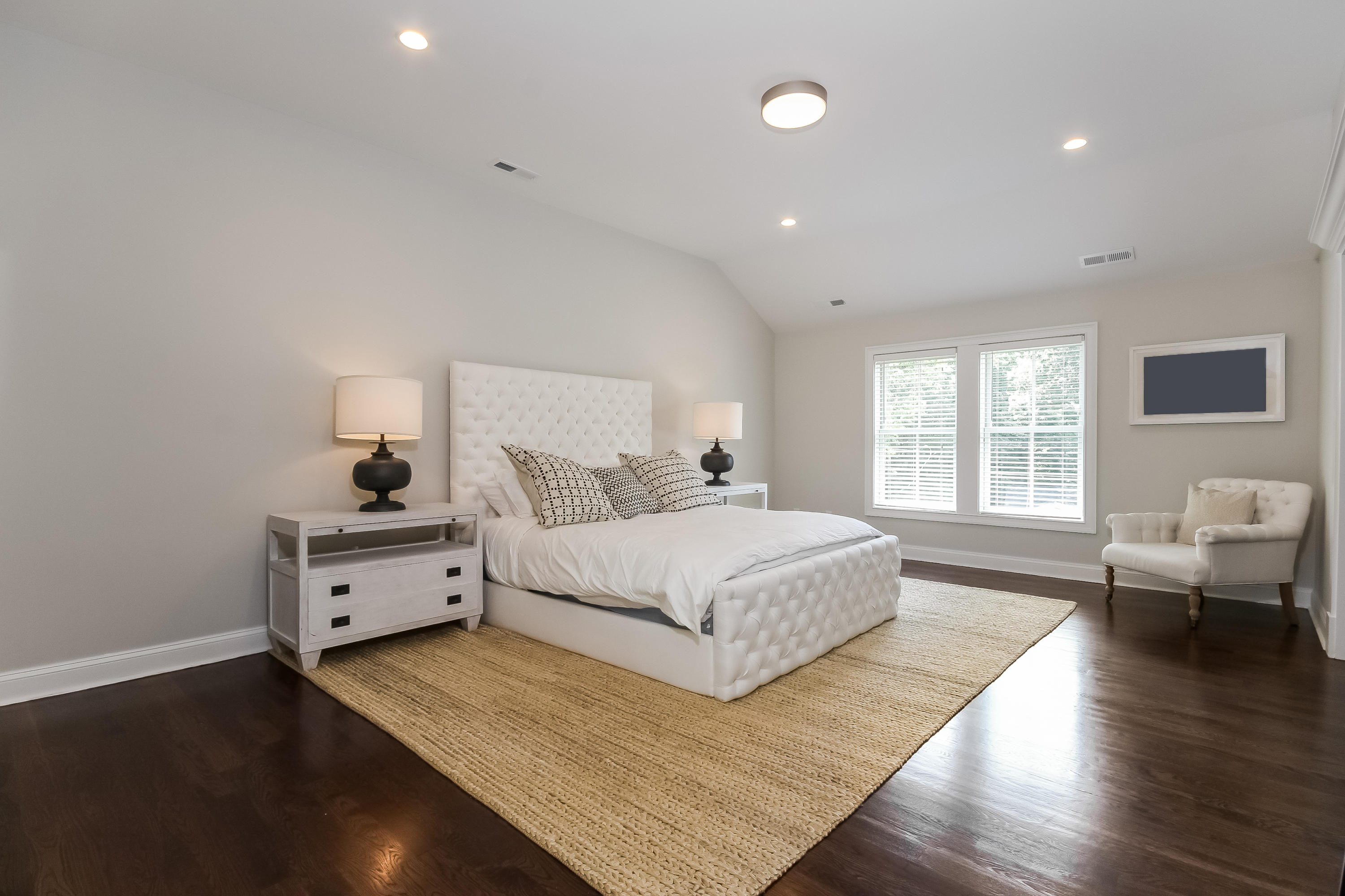 100 Leeuwarden Road Darien, CT 06820 - Photo 34 of 70 a spacious bedroom with a large bed and wooden floor