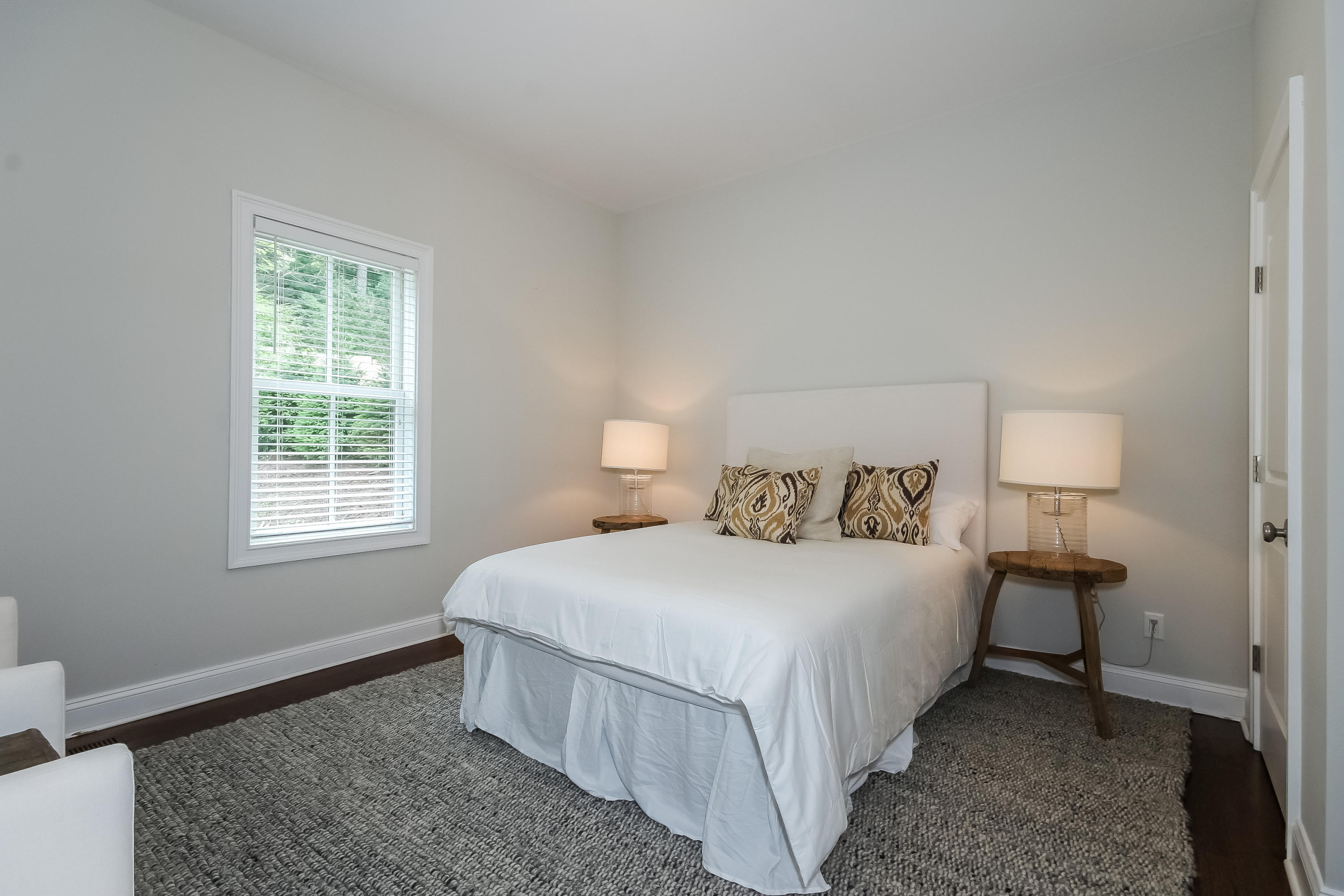100 Leeuwarden Road Darien, CT 06820 - Photo 41 of 70 a bedroom with a bed lamp and a window