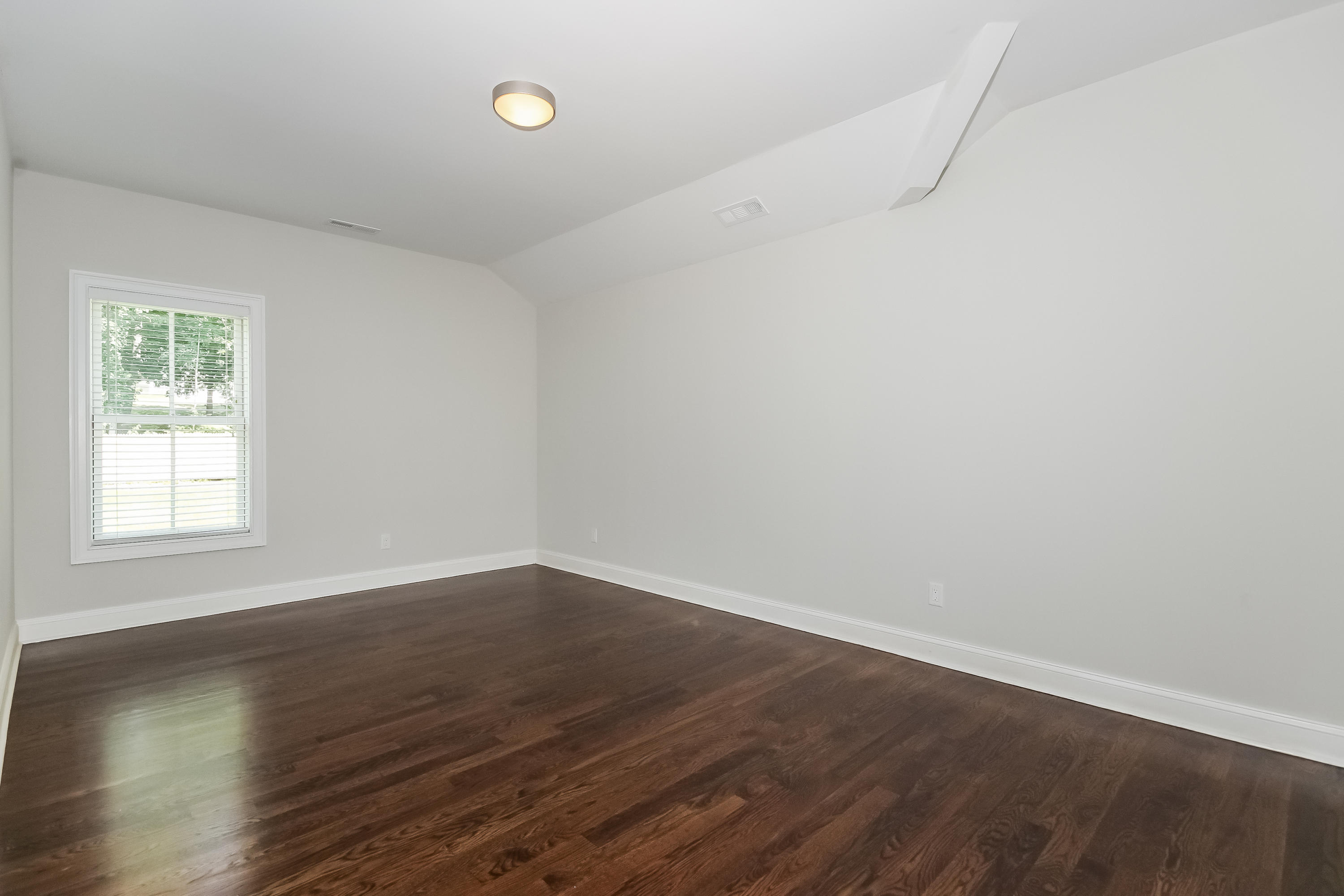 100 Leeuwarden Road Darien, CT 06820 - Photo 49 of 70 an empty room with wooden floor and windows