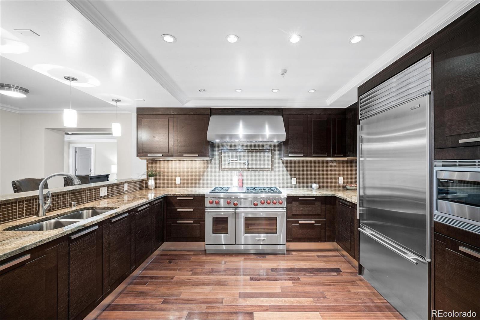 1891 Curtis Street, Unit 1607 Denver, CO 80202 - Photo 12 of 47 a large kitchen with stainless steel appliances and a sink