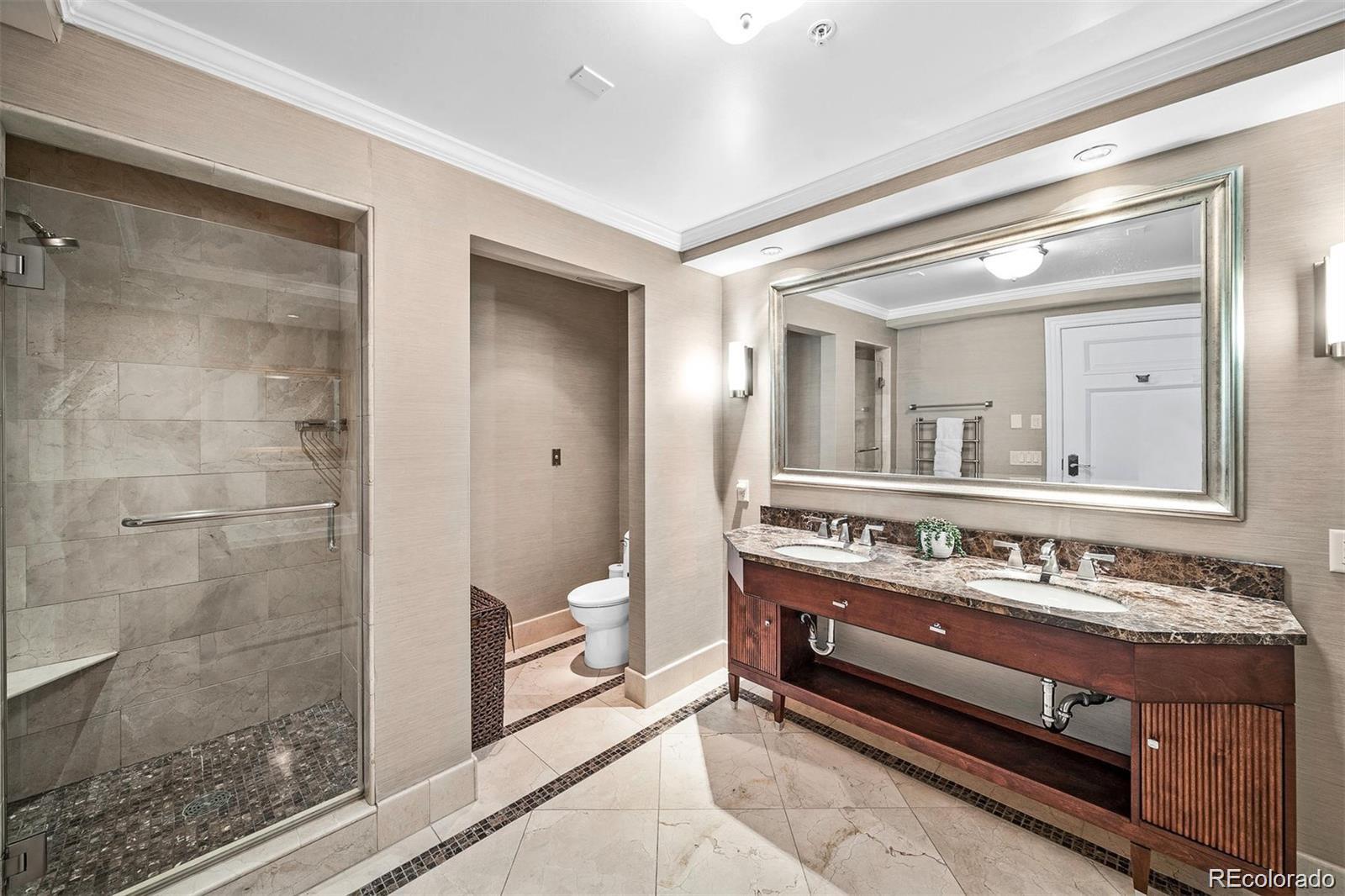 1891 Curtis Street, Unit 1607 Denver, CO 80202 - Photo 18 of 47 a bathroom with a double vanity sink and a mirror