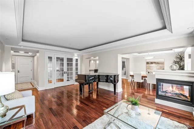 a living room with fireplace furniture and a wooden floor