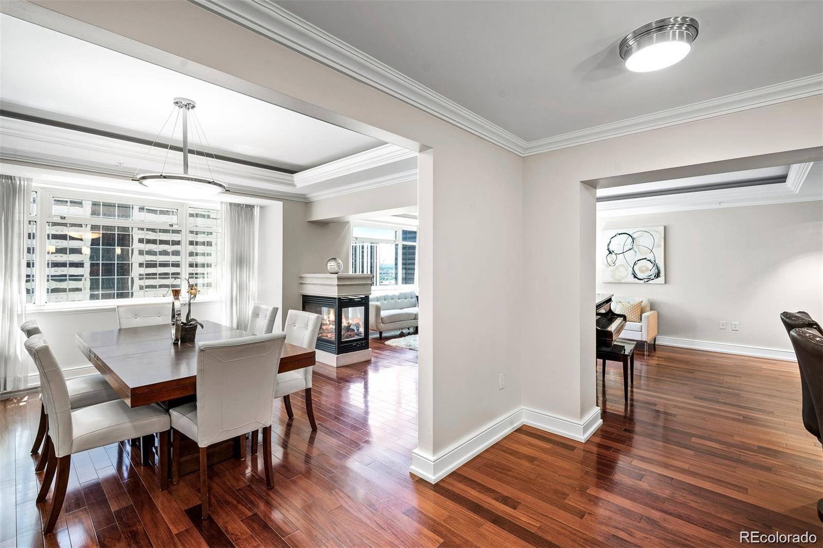 1891 Curtis Street, Unit 1607 Denver, CO 80202 - Photo 2 of 47 a view of a dining room with furniture window and wooden floor